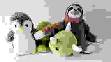 Three weighted stuffed toy animals assembled together on marble countertop.