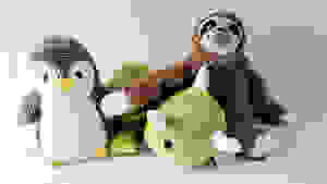Three weighted stuffed toy animals assembled together on marble countertop.