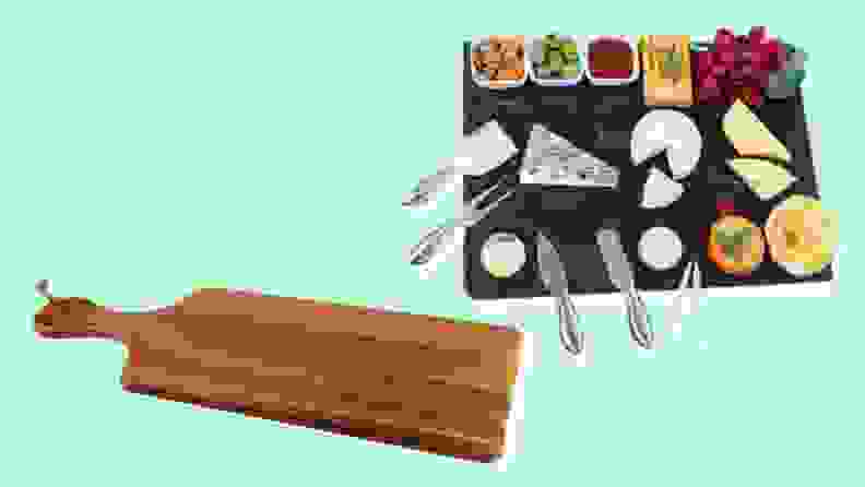 Empty wooden cheese board and slate cheese board filled with cheese on a blue background
