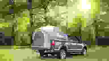 Photo of the sun and a truck bed tent.