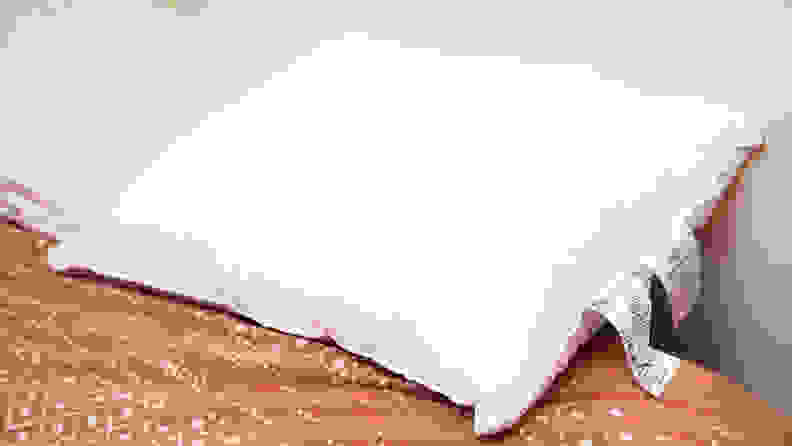 the AmazonBasics soft density pillow on a bed