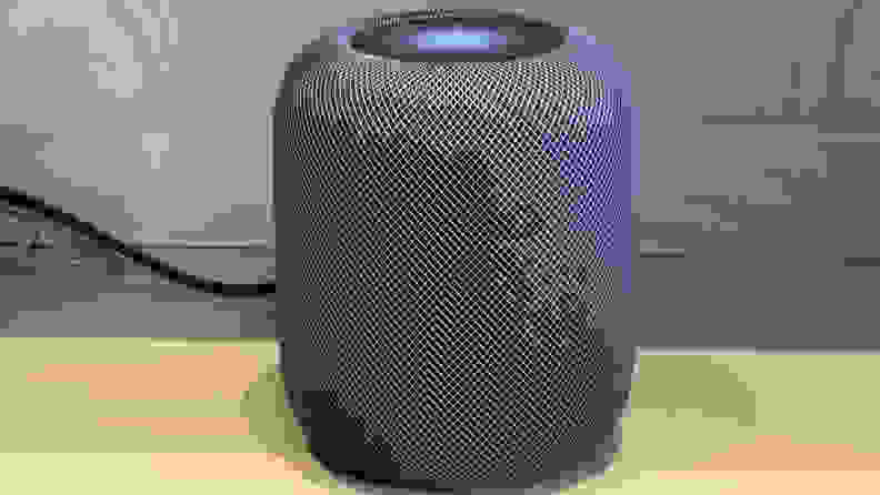A second-gen Apple HomePod sits on a desk