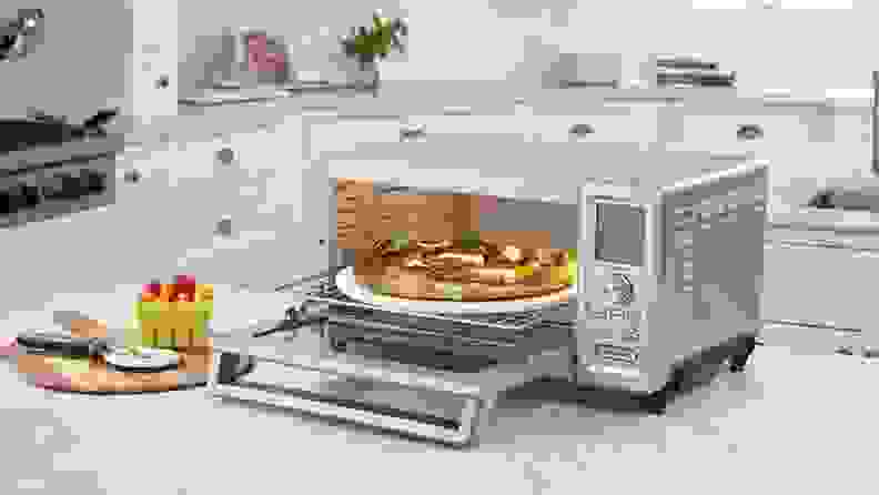 Cuisinart toaster oven on a kitchen counter with a pizza inside