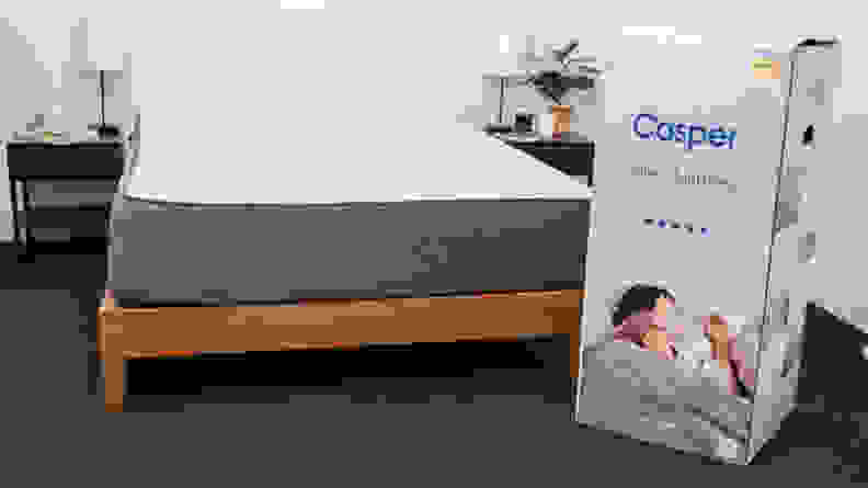 the casper select on a bed frame next to the box