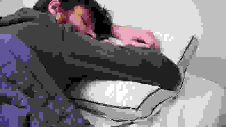 a man sleeps on the Coop Home Goods Eden pillow