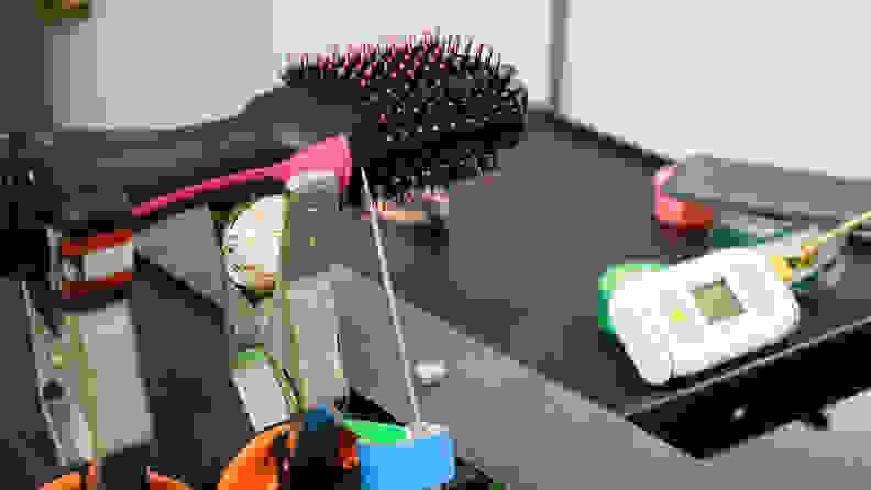 A hair dryer brush sitting with a temperature probe resting against it.