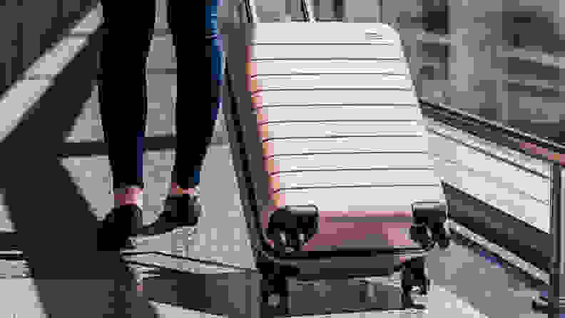 Away carry-on luggage being pulled in airport
