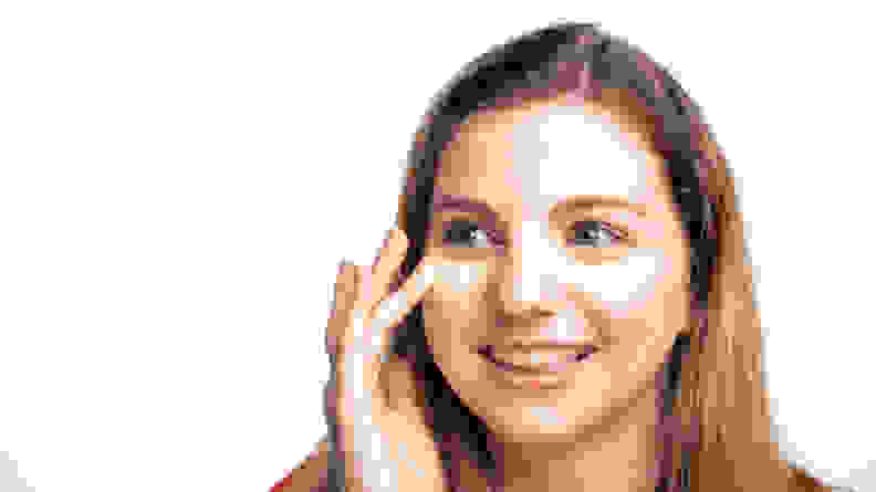 The author applying concealer under her eyes.