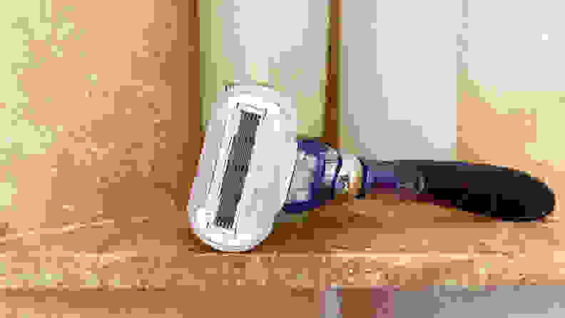 The Gillette Venus Extra Smooth Swirl laying on a shower shelf with body wash behind it.