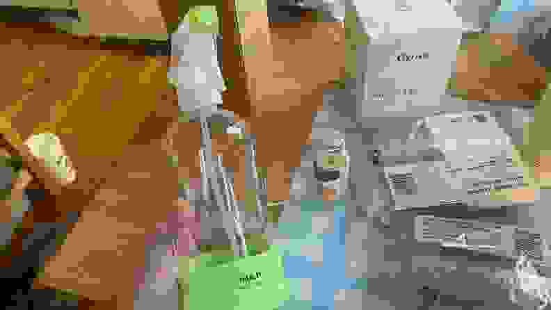 A hand holding out a spray bottle of multi-purpose cleaner by Grove Co.