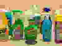 An array of shower cleaners, situated in a small shower around a drain.