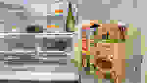 A shot of the interior of a fridge, focusing on its door bins and the lower half of its refrigerator compartment. The fridge is stocked with food.