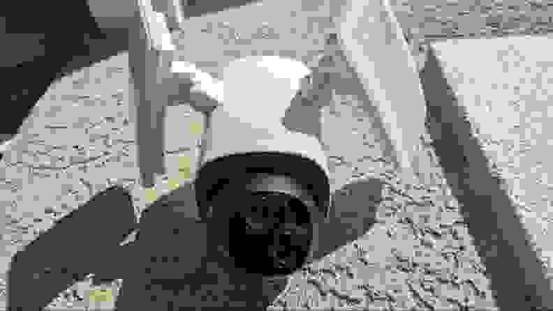 The Eufy Floodlight Cam E340 mounted on a home's beige stucco wall