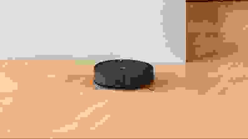 The iRobot Roomba Combo Essential mopping hardwood and vacuuming crumbs.