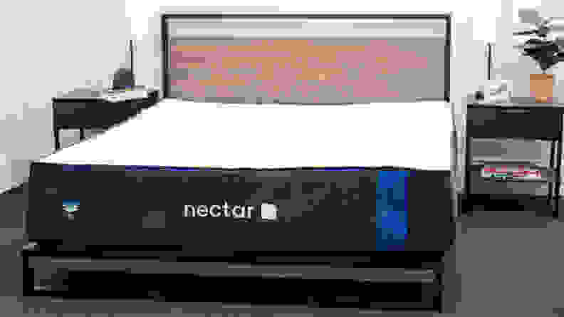 The Nectar mattress appears in a bedroom with bedside tables on either side.