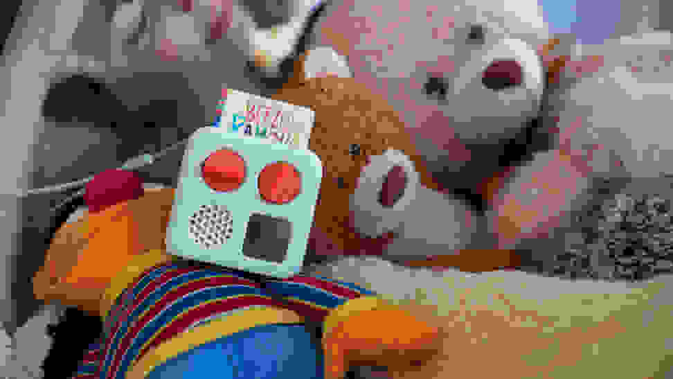 The Yoto Mini on a bed of cute stuffed animals.