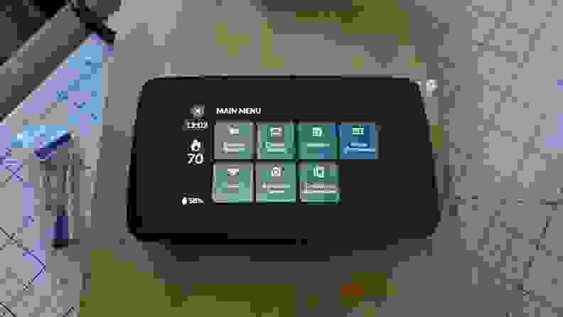 The photo shows the LCD screen of the Sensi Thermostat set to on and displaying the main menu.