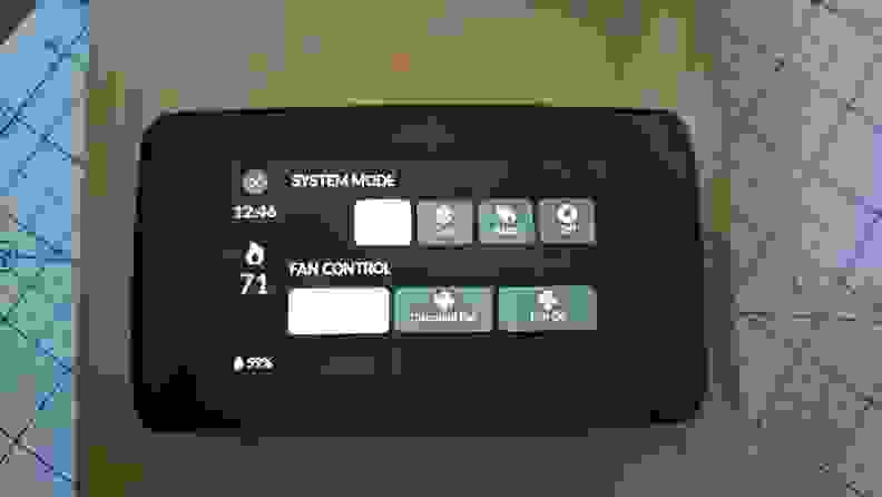 The Sensi Touch 2 appears with system mode and fan control displayed on its LCD touchscreen.