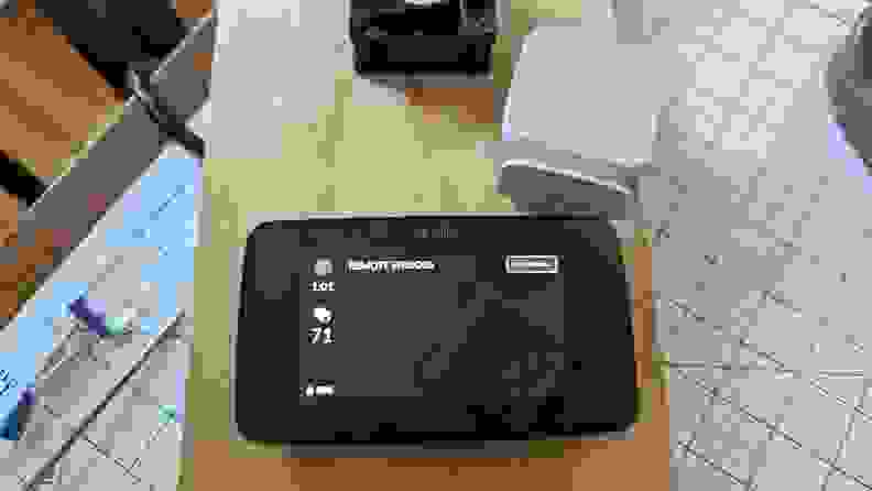 The photo shows the Sensi thermostat mounted on a wood panel with a sensor.