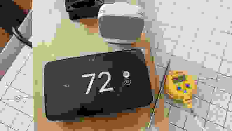 The Sensi thermostat appears mounted on a simulated HVAC rig with a sensor and testing thermometer.