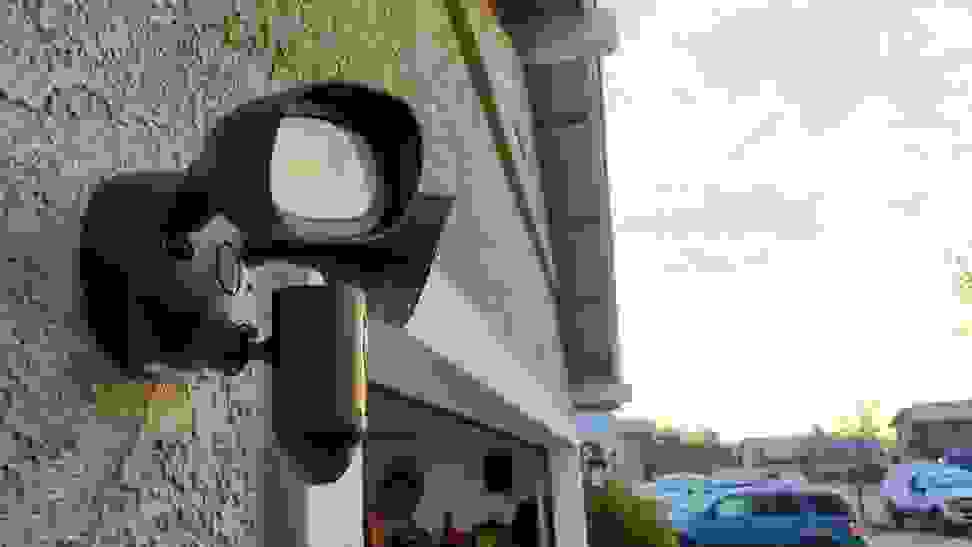 The Ring Floodlight hanging on the side of a home above a garage during the daylight