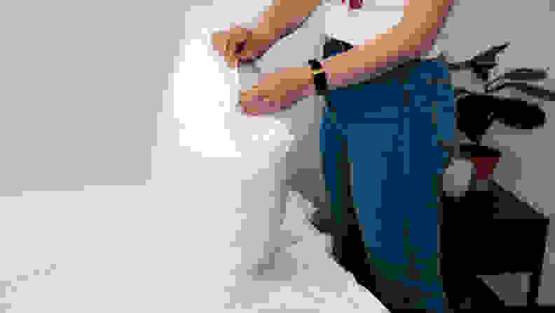 a woman holds a pillow in the target room essentials pillow protector