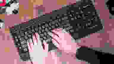 Hands typing on a keyboard
