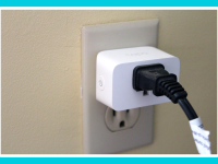 Black utility plug connected to the Tapo Smart Plug Mini in wall.