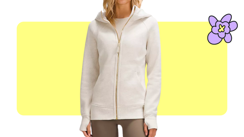 A model wearing the lululemon Scuba Full-Zip Hoodie in Heathered Bone/Gold color and tan leggings.