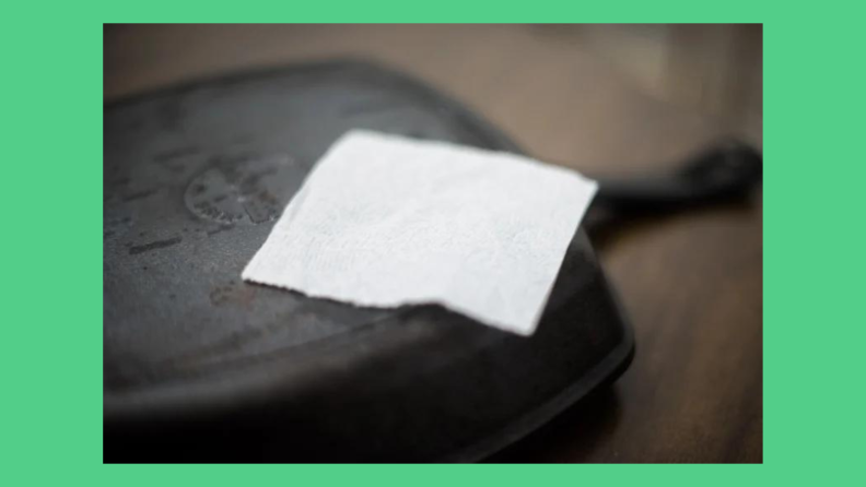 A sheet of toilet paper sits on a cast iron pan