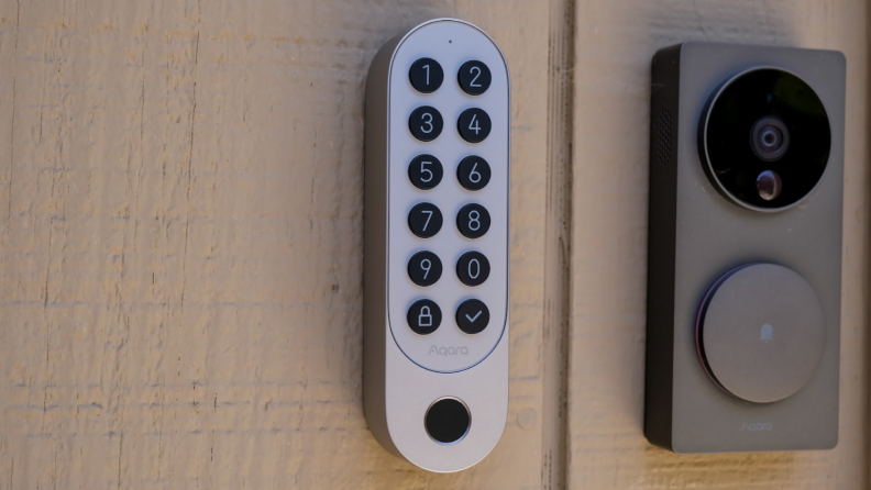 The Aqara U200 smart lock keypad hanging on the outside of a door