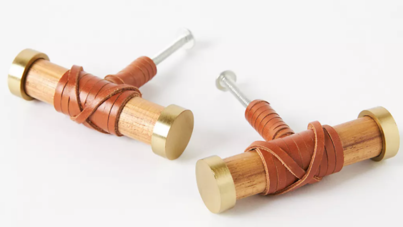 Two teakwood cabinet handles side by side
