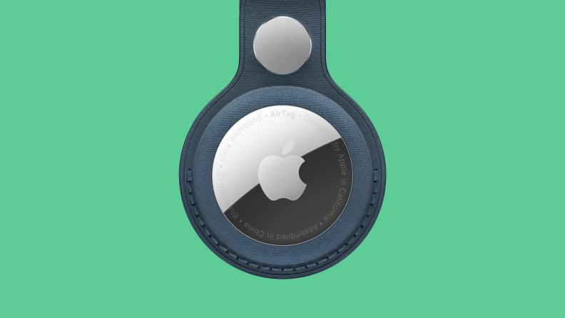 Apple Airtag in leather loop on colored background
