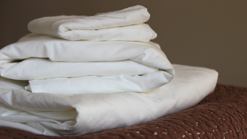 A stack of folded Boll & Branch percale sheets.