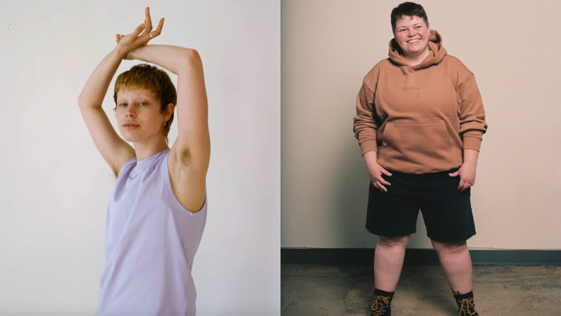 One person wearing a tank top with their arms above their head next to a person wearing shorts and a sweatshirt standing in front of a wall and smiling.