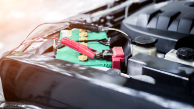 Charging car with electricity and jumper cables.