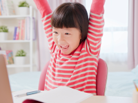 Little girl having fun on a laptop computer.