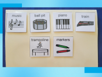 Children's sensory board with picture illustrations attached.