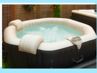 Inflatable hot tub pool with headrests and cup holders.