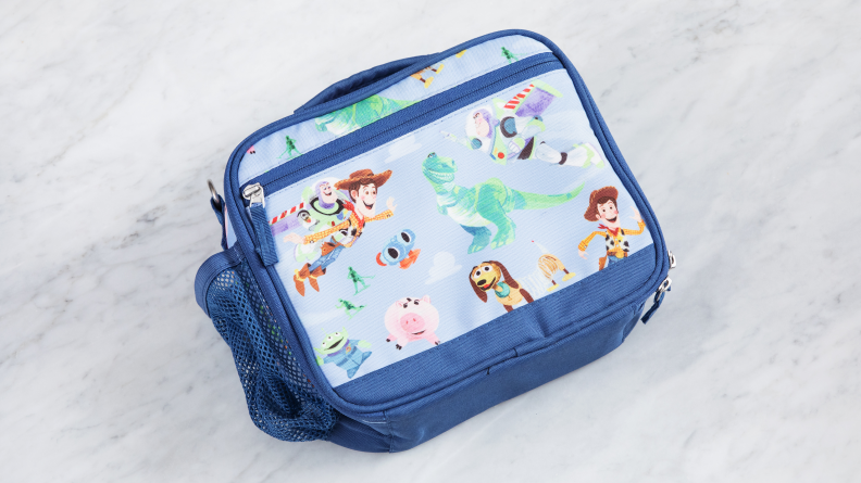 Toy Story-themed Pottery Barn Kids Mackenzie Cold Pack Lunch Box on a marble counter.