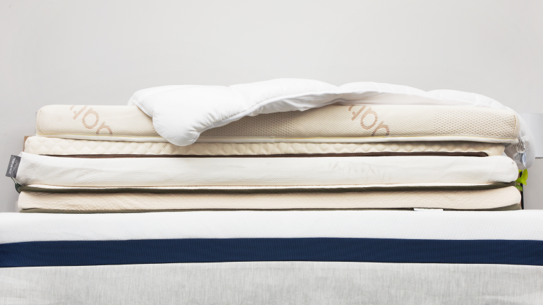 A stack of mattress toppers on top of a mattress.