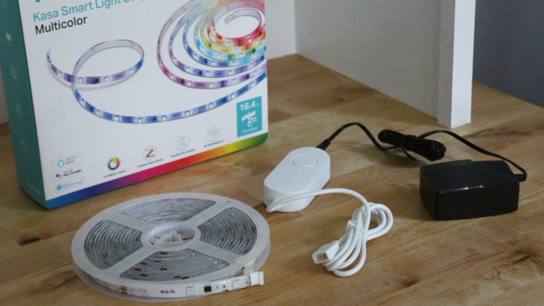 The Kasa Light Strip sitting on a table next to the packaging