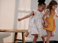 Two little girls playing hopscotch