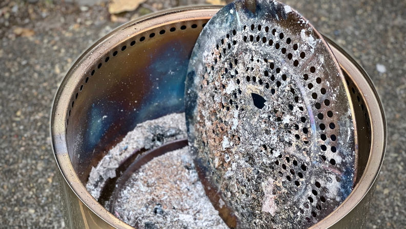 Ash pan on Solo Stove Fire Pit 2.0 filled with old ash.